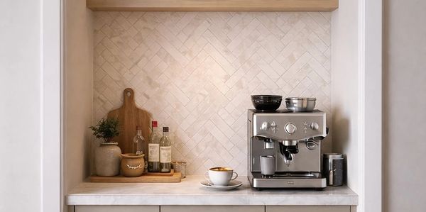 Minimalist coffee station with espresso machine and accessories.