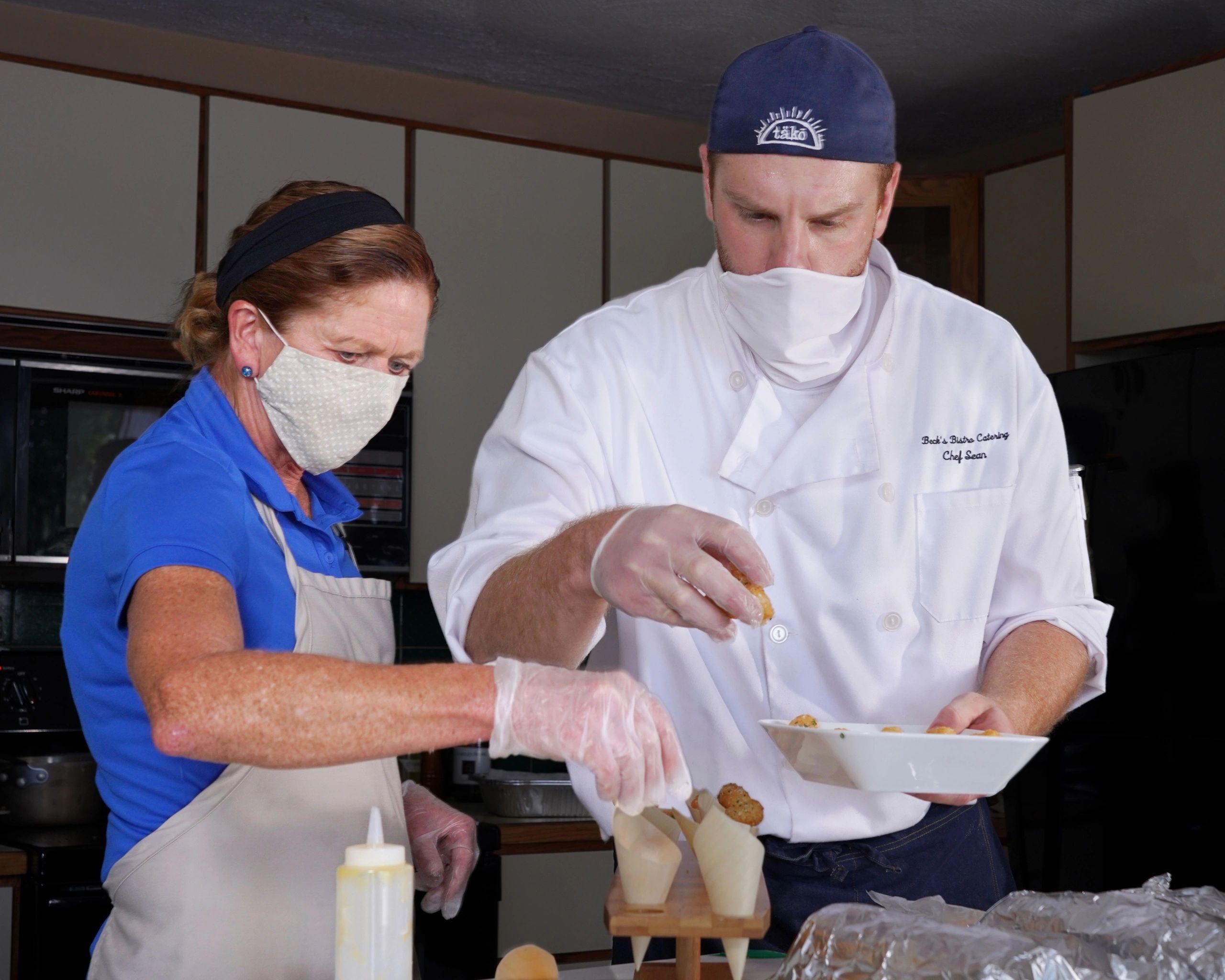 Chef Sean and Judy preparing individual truffled tater tots