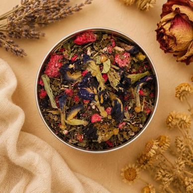 Tin of dried herbal tea with flowers and leaves.