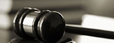 Close-up of a judge's gavel on a desk.