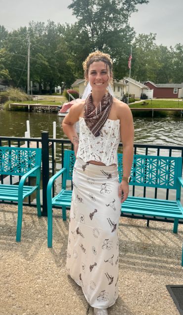 Bride to be smiling by a lakeside on bachelorette party.
