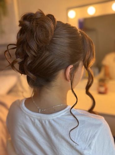 Elegant updo hairstyle with curled strands.