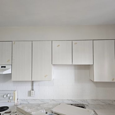 Kitchen cabinet restoration, painting and installation.