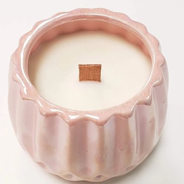 Luxury handmade wooden wicked fragrance candle in a large pink ceramic pot.