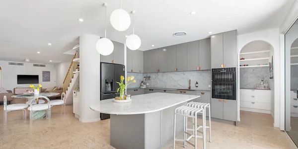 Modern kitchen with grey cabinetry and marble stone benchtops, professionally fabricated and installed by a Gold Coast stonemason servicing Brisbane and SE QLD.