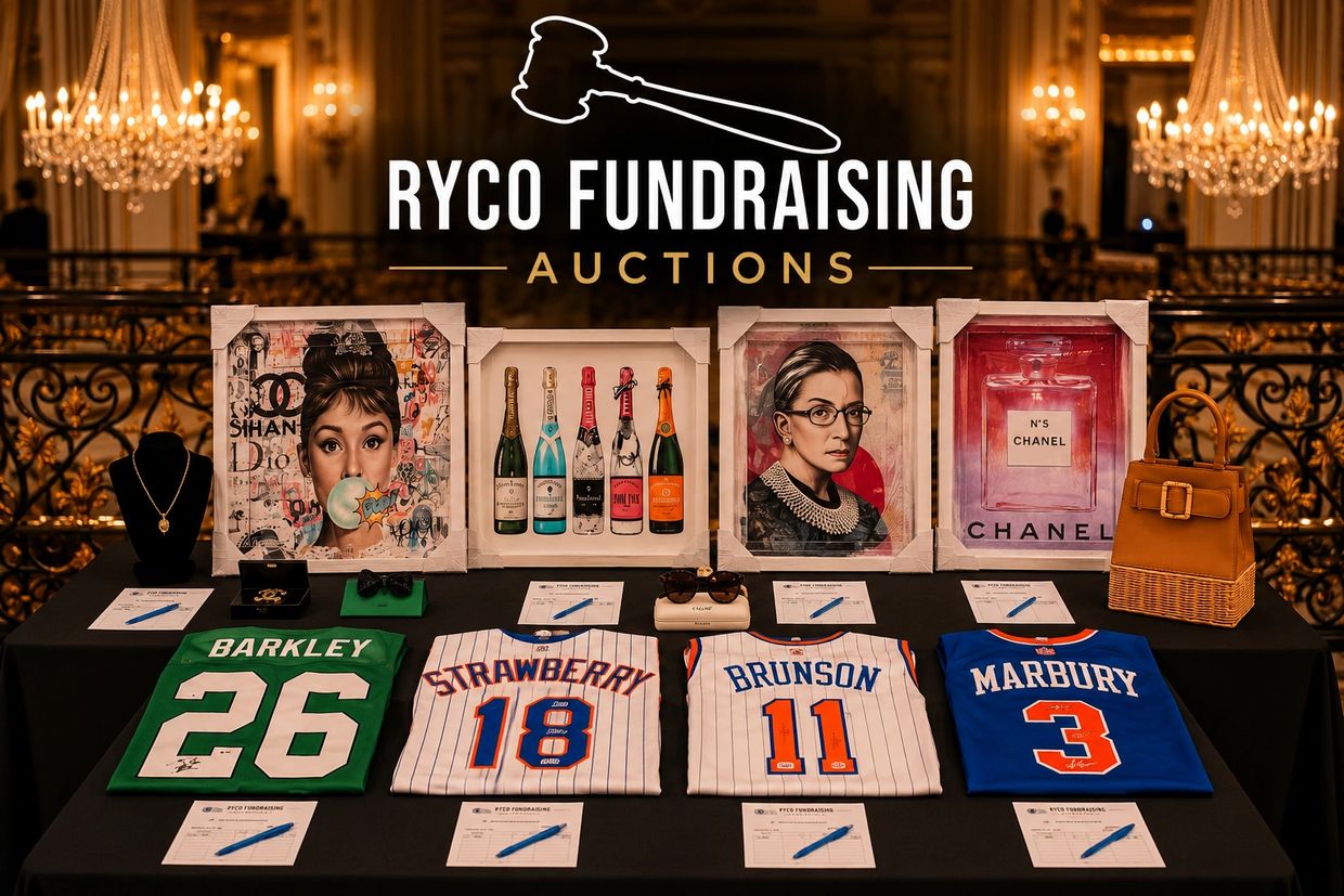 Table with auction items including jerseys, artwork, and accessories at RYCO Fundraising event.