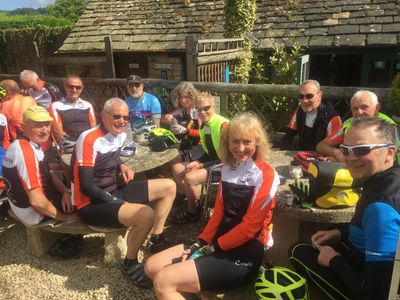 Cyclists in a cafe at Lower Slaughter, Cotswolds.