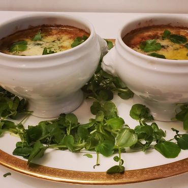 Coquille St. Jacques Scallops in two Bowls on Bowl in Platter with Watercress