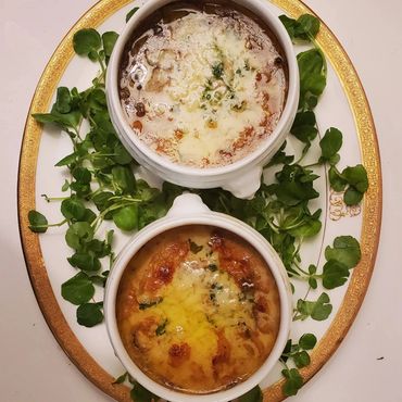 Coquille St. Jacques Scallops with and without spinach in bowls on platter overview