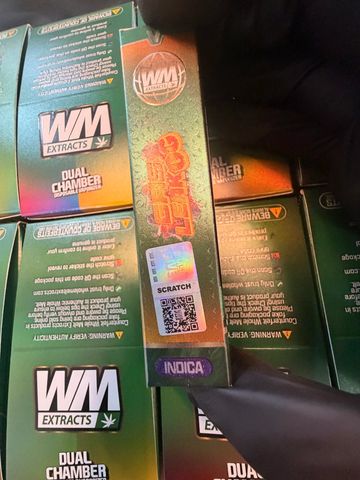 Boxes of WM Extracts cannabis products with security labels.