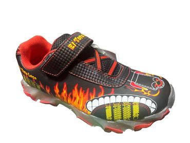 Black and red sneaker with flames and teeth design, featuring a velcro strap.