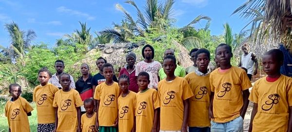 Group of kids standing together by wearing yellow shirts