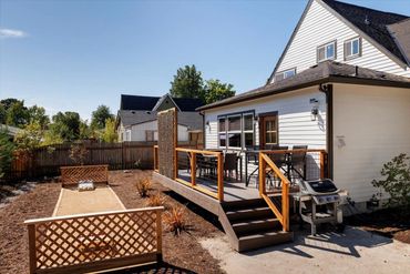 Backyard deck has seating for 12, gas grill. Enjoy corn hole in the custom court