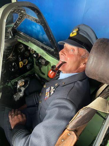 90-year-old man having an experience in a spitfire simulator