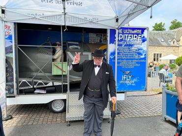 Ifly Spitfire Simulator at an event and Churchill actor standing outside