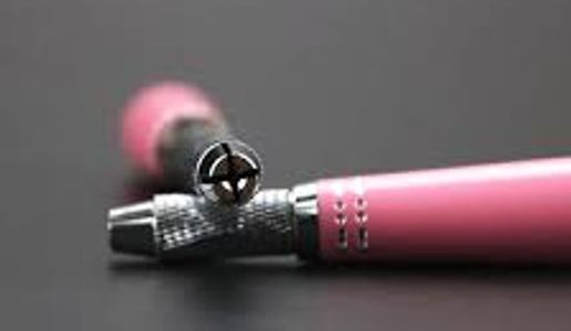 Manual Microblading tool with silver metal and a pink handle