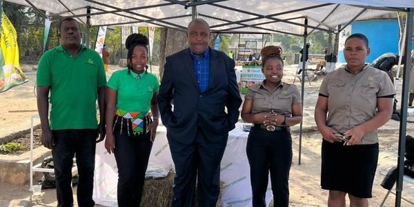 Five people standing under a tent promoting cereal and porridge products.