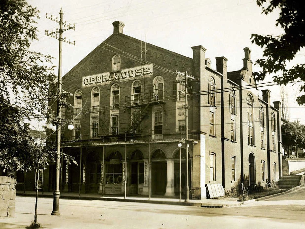 Vintage photo of the Obermayer building on a street corner.