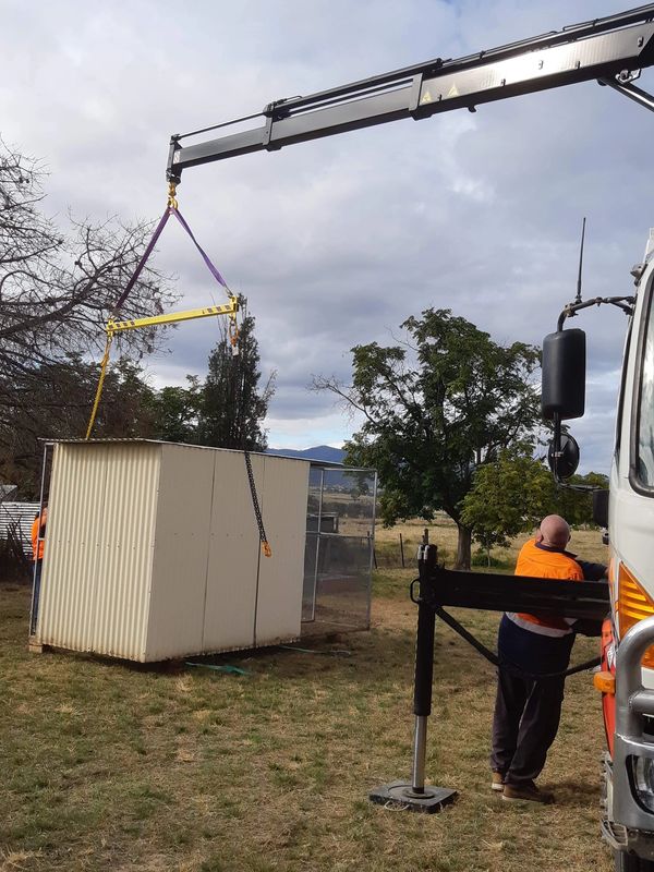 Crane and spreader bar makes for a careful placement of this birdcage.