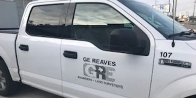 A company truck with the logo on the front 