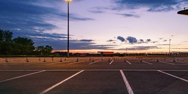 An empty parking lot with a sunset 
