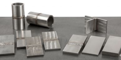 Various metal weld samples on a flat surface.