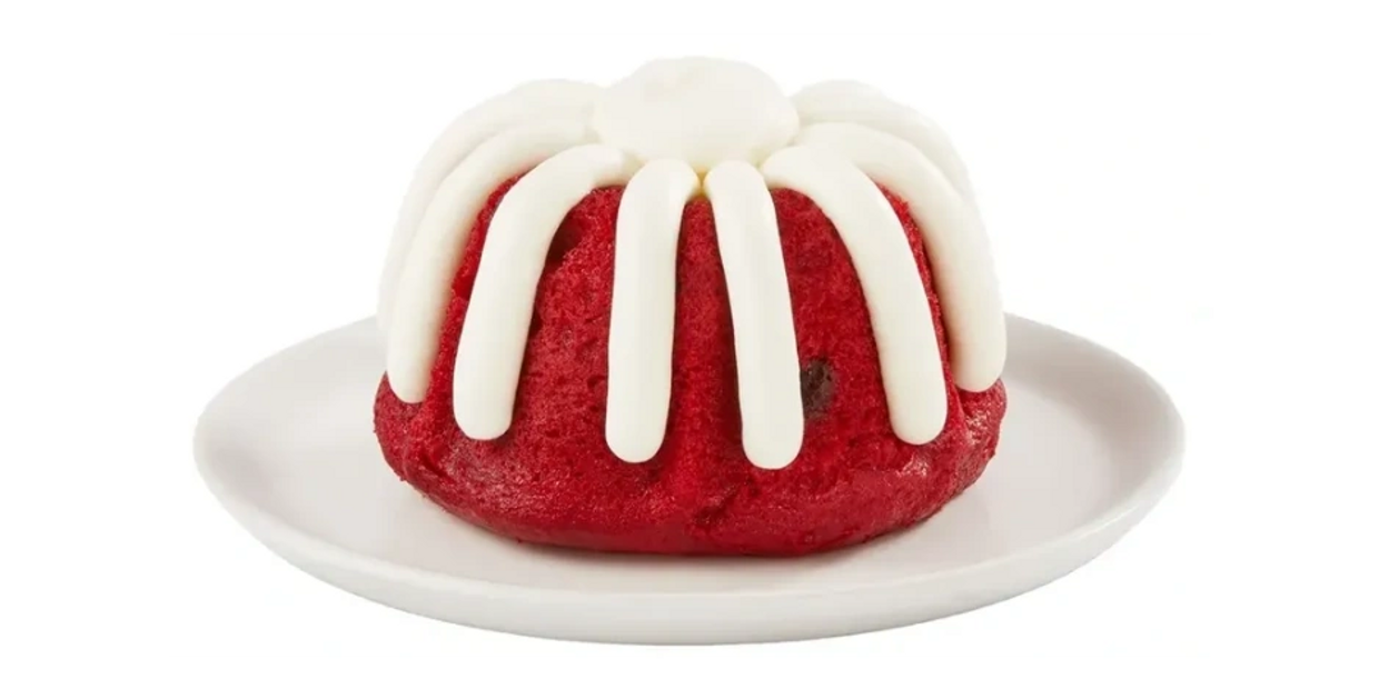Red velvet mini bundt cake with white icing on a white plate.