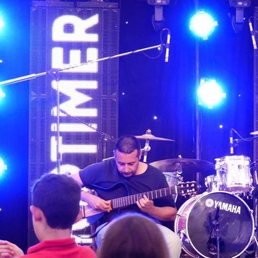 Cumbrian Guitarist playing at a festival.