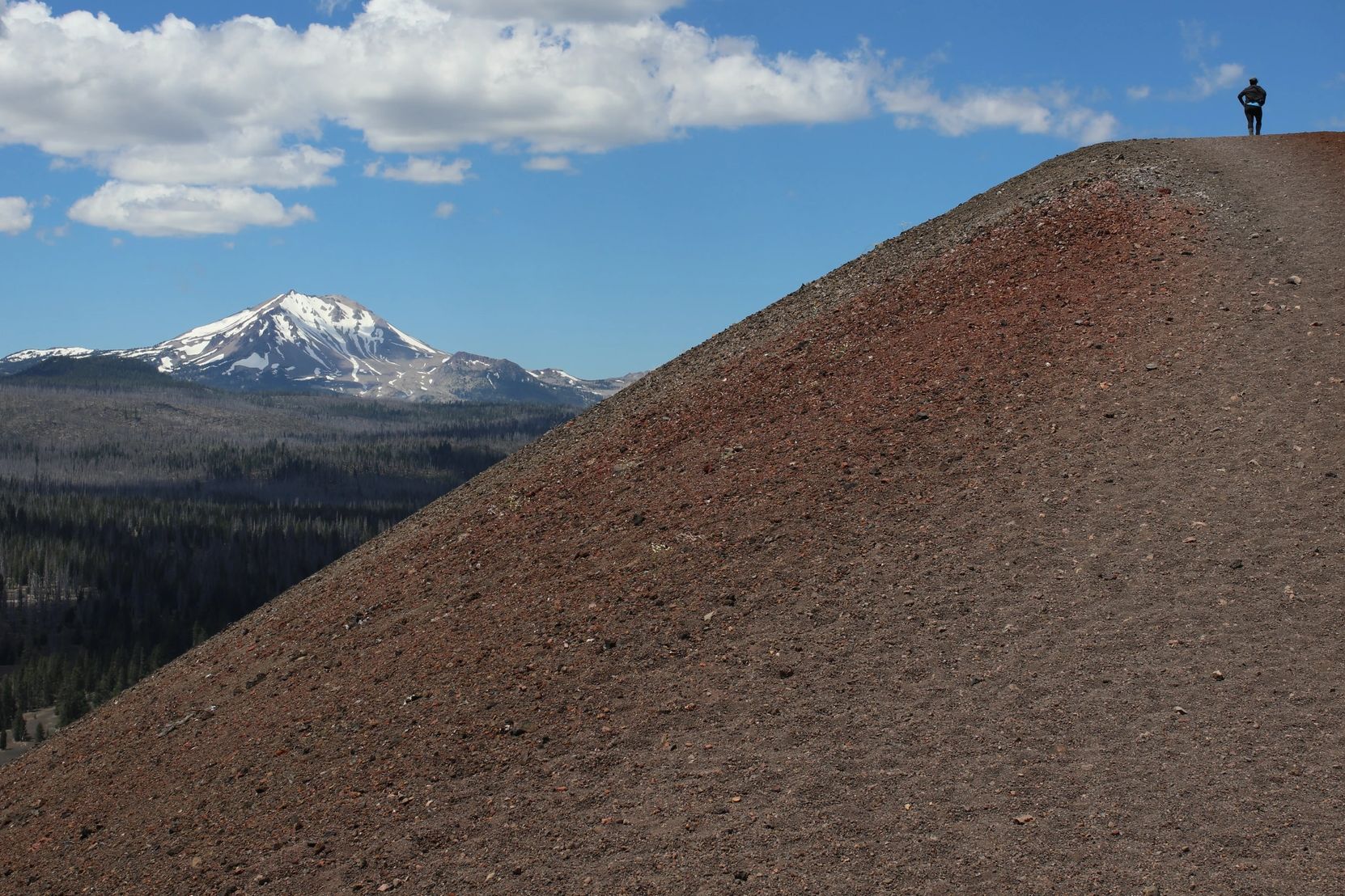 A lone hiker summits the cinder cone to overlook Mt. Lassen.  ~photo by Timbre Beck, rights reserved