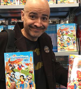 Yancey posing with DC Super Hero books