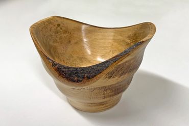 JonT's asymmetric, live edge bowl - the wood is unknown but the quality is undeniable. Dec 2025