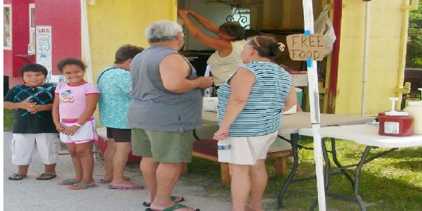 People gathered at a free food distribution stand.