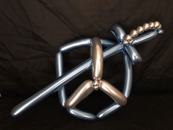 a chrome balloon sword and shield made by an award winning balloon artist