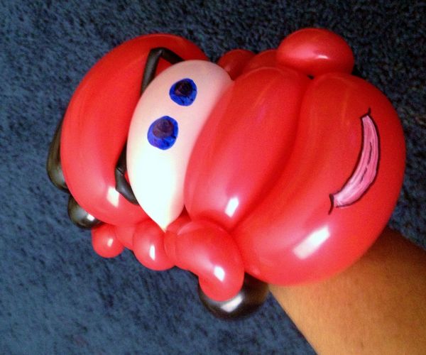 latex balloon twisted into the shape of a red race car