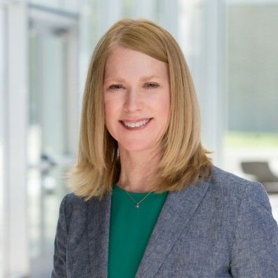 Professional woman smiling in business attire.