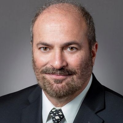 Professional portrait of a middle-aged man in a suit and tie.