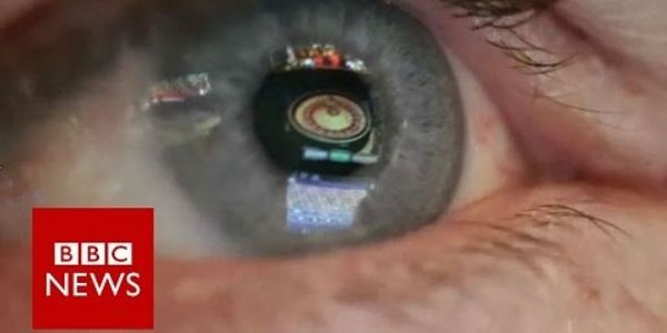 Photo of a blood shot eye with roulette wheel image reflecting from the pupil. Image by BBC News.