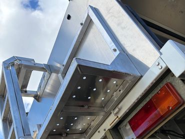 Metal platform and ladder mounted on a truck with Queensland license.