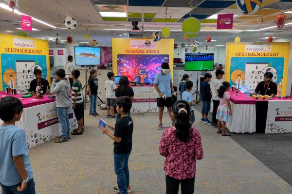 Children engaging in Science activities and VR gaming at AstraZeneca Family Day.