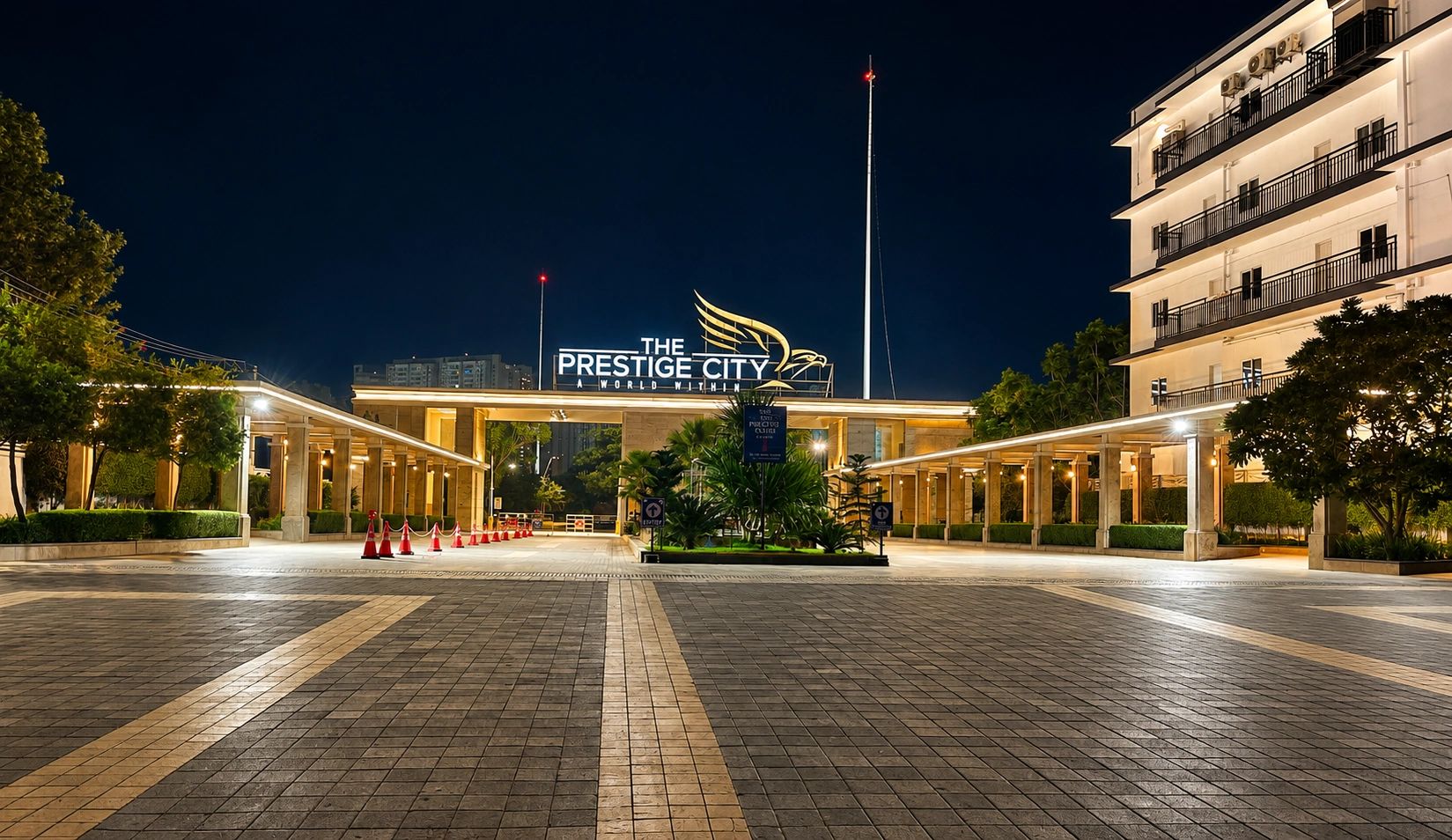 Night view of The Prestige City entrance with illuminated signage.