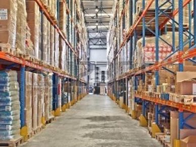 Warehouse aisles with stacked boxes on shelves.