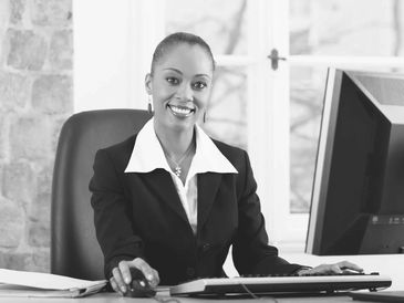 a woman sitting at a desk with a computer