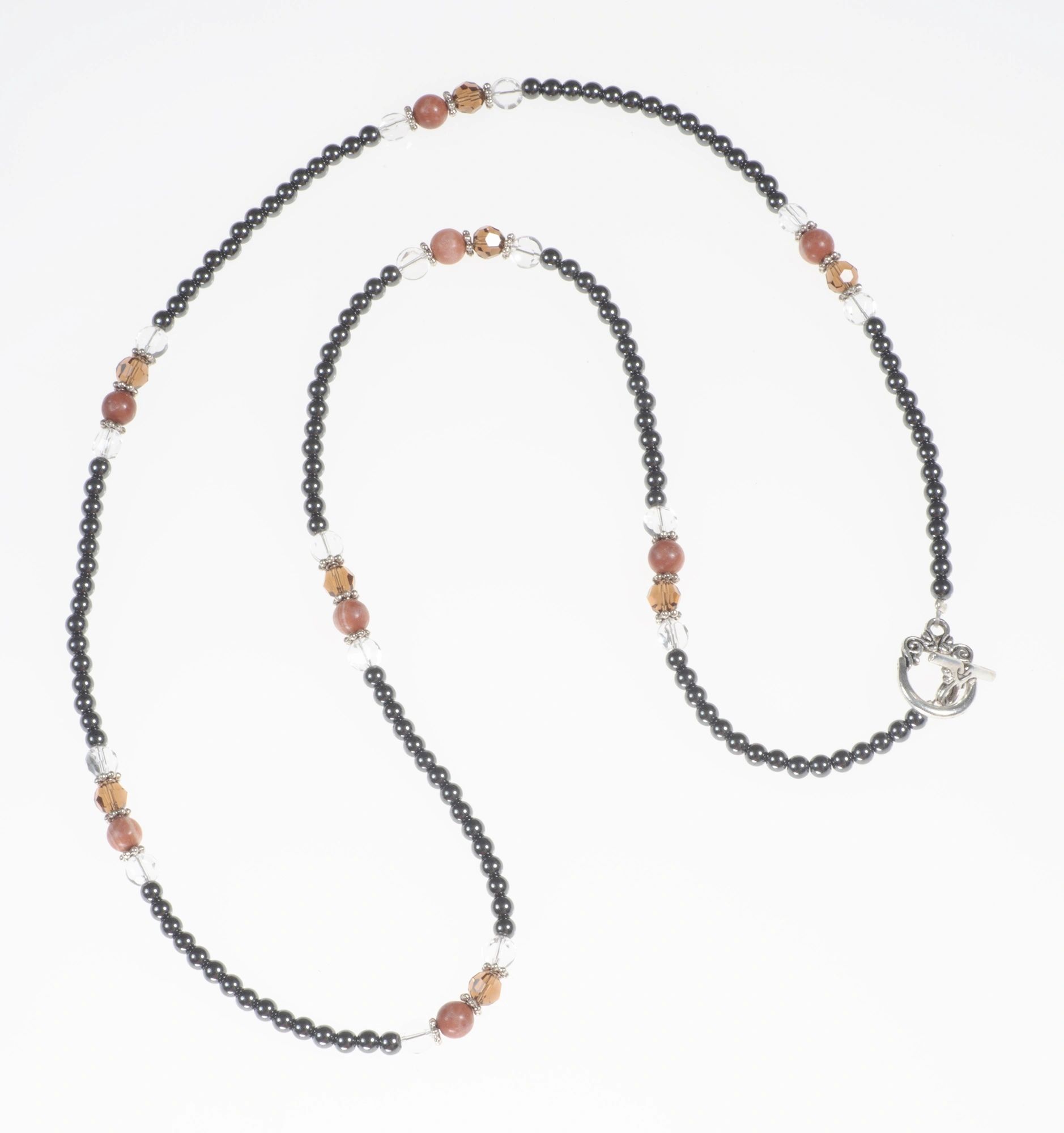 Necklace has Swarovski dark topaz crystals,red beads, round clear beads,hematite,toggle clasp