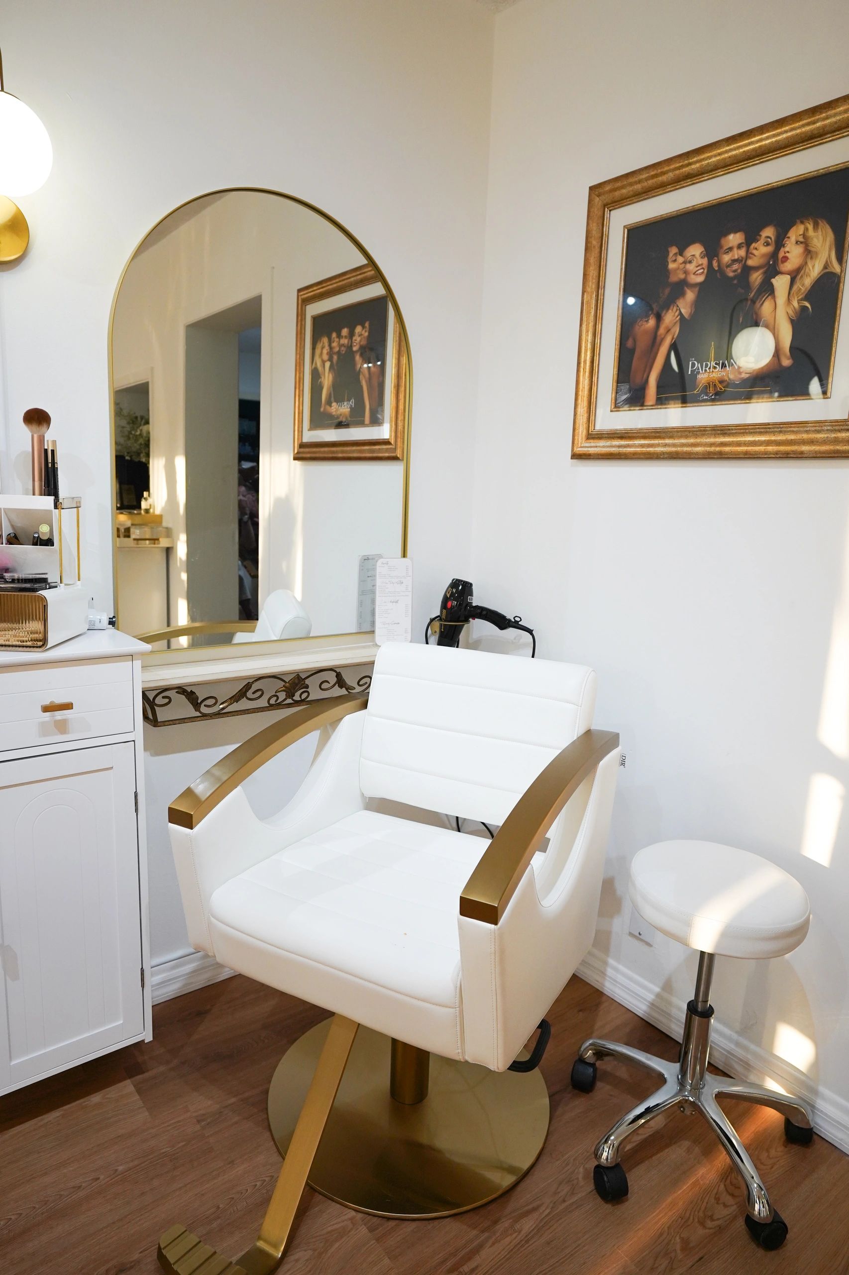 Bright salon with arched mirrors, styling chairs and wood floors at The Parisian Hair Salon, Largo