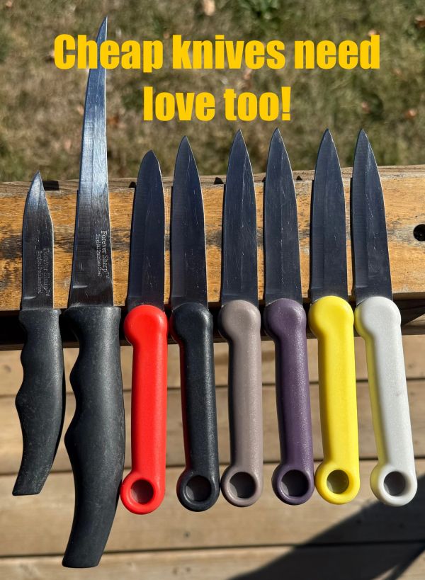 Row of assorted cheap knives with colorful handles and text saying they need love too.