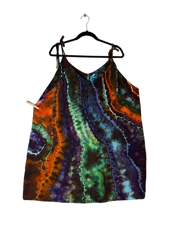 Tie dye top with vibrant green, blue, orange, and purple patterns