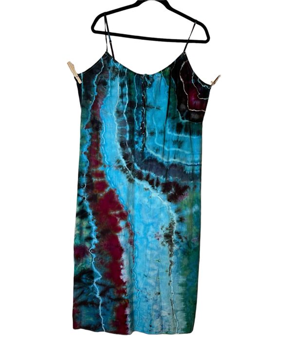 Hand-dyed dress with blue, green, and burgundy patterns.