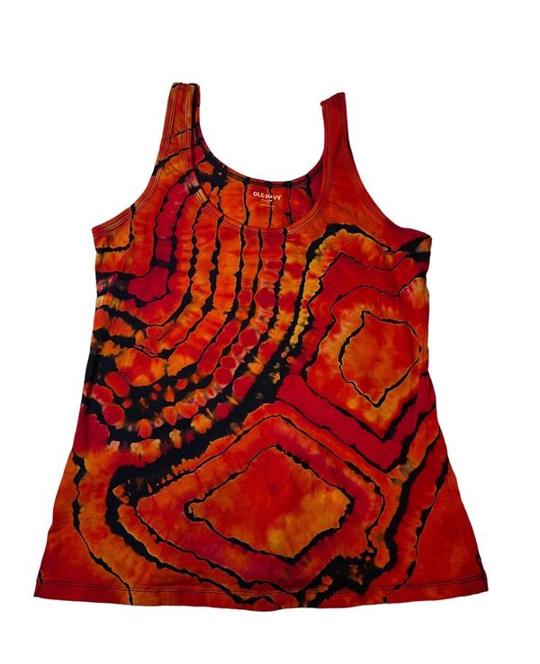 Reverse tie dye tank top with vibrant red, orange, and black patterns.