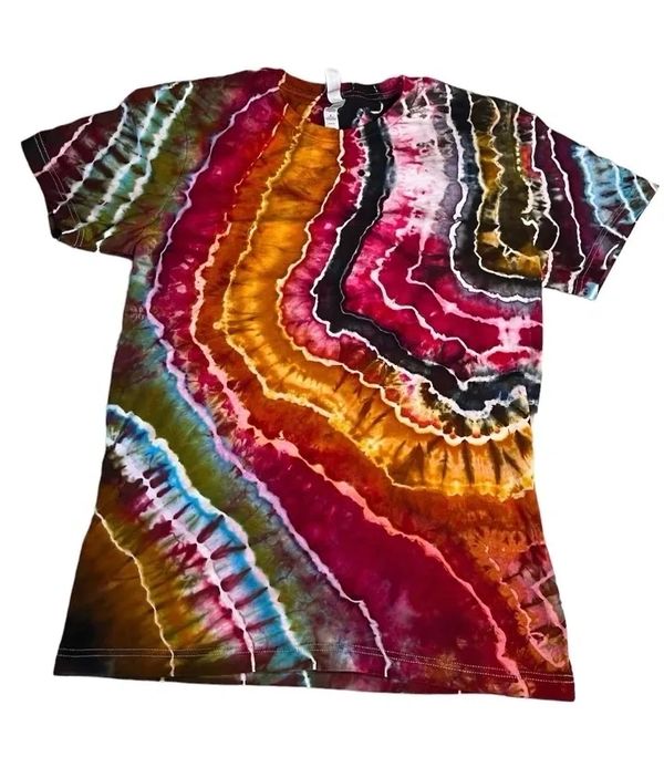 Hand-dyed t-shirt with vibrant red, orange, yellow, and blue patterns.