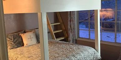 Queen bed on top of queen bed with all kinds of head room and incredibly comfy pillows & duvet fills